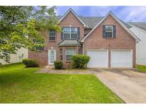 Charming two-story brick home with a well-manicured lawn and two-car garage, perfect for a Gathering at 4185 Post Oak Grv, Atlanta, GA 30349