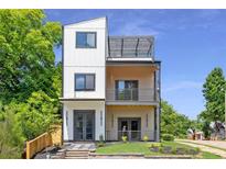 Stunning modern home with three stories and beautiful balconies and clean, neutral colors at 941 Garibaldi Sw St, Atlanta, GA 30310