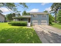 Charming two-story home with a well-manicured lawn and a two-car garage at 58 6Th W Ave, Dallas, GA 30157