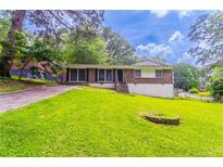 Charming brick home with a lush green lawn, offering a welcoming curb appeal at 4337 Brookside Dr, Forest Park, GA 30297