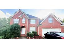 Lovely two-story brick home with well-maintained landscaping and an attached two-car garage at 350 Glynnshire Ct, Covington, GA 30016