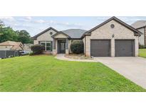 Charming single-Gathering home with a well-manicured lawn and an attached two-car garage at 80 Pulaski Pl, Jonesboro, GA 30238
