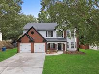 Charming two-story home with a well-manicured lawn and a two-car garage at 160 Magnolia Walk Ln, South Fulton, GA 30349