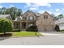 Charming brick home featuring a manicured front yard and a welcoming two-car garage at 1701 Tipton Nw Ct, Acworth, GA 30101