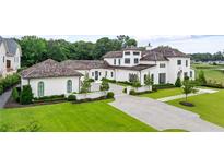 Beautiful white stucco home with a lush green lawn and manicured landscaping at 1640 Kenai Rd, Kennesaw, GA 30152