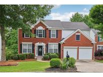 Charming two-story brick home with attached two-car garage and manicured landscaping at 2508 Haddenham Sw Ln, Smyrna, GA 30082