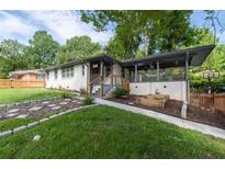 Charming home featuring a landscaped front yard with stone pathway and covered porch at 1261 Calhoun Sw Ter, Atlanta, GA 30314