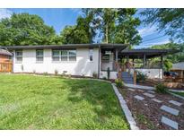 Charming home featuring a well-manicured front yard and stylish walkway to the front porch at 1261 Calhoun Sw Ter, Atlanta, GA 30314