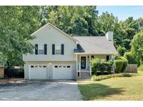 Charming two-story home with a well-maintained lawn, two-car garage, and traditional architectural details at 127 Muirwood Dr, Temple, GA 30179