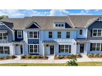 Charming new construction townhomes featuring brick facades, well-manicured lawns, and inviting entryways at 2472 Honey Way, Conyers, GA 30013
