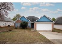 Charming single-Gathering home with blue trim, brick accents, and an attached two-car garage at 4931 Wilkins Station Dr, Decatur, GA 30035