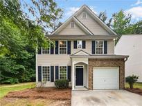 Charming two-story home with brick accents, a well-manicured lawn, and a welcoming front entrance at 6240 Shenfield Ln, Union City, GA 30291