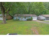 Charming single-story home with light blue siding and a well-maintained front yard at 5012 Galbraith Cir, Stone Mountain, GA 30088