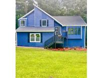Charming blue two-story home with well-maintained lawn and inviting front entrance at 3706 Londonderry Ct, Lithonia, GA 30038