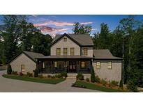 Charming two-story brick home with a welcoming front porch and professionally landscaped yard at 313 Anderwood Rdg, Marietta, GA 30064