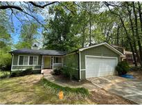 Charming single-story home with a well-manicured lawn and attached two-car garage at 921 Hemingway Rd, Stone Mountain, GA 30088