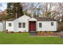 Charming one-story home with white siding, a red front door, and a well-manicured lawn at 1349 Lockhaven Sw Cir, Atlanta, GA 30311