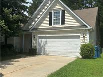 Charming home with a two-car garage and mature landscaping at 76 Daisy Meadow Trl, Lawrenceville, GA 30044