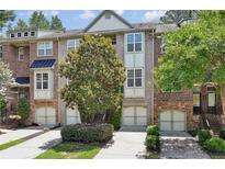 Charming townhome with a brick facade, attached garage, and well-maintained landscaping at 1986 Cobblestone Ne Cir, Atlanta, GA 30319