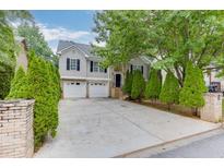 Charming two-story home with a two-car garage, well-maintained lawn, and mature trees at 571 Oak Vista Ct, Lawrenceville, GA 30044