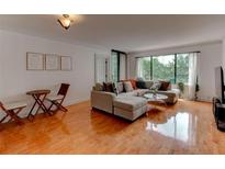 Bright living room featuring a large sectional sofa and hardwood floors, perfect for relaxing and entertaining at 3481 Lakeside Ne Dr # 902, Atlanta, GA 30326