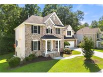 Charming two-story brick home with a well-manicured lawn and inviting front porch at 733 Miller Run Run, Atlanta, GA 30349
