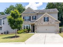 Charming two-story brick home with well-maintained landscaping and a two-car garage at 2099 Lakeview Bend Way, Buford, GA 30519