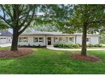 Charming one-story home featuring a manicured lawn and classic white brick exterior with gray shutters at 3581 Ridge Se Rd, Smyrna, GA 30080