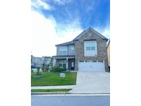Charming two-story home with a well-manicured lawn and a two-car garage at 2300 Ivy Birch Ln, Buford, GA 30519