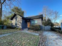 Charming home featuring a well-maintained lawn and a welcoming, bright yellow front door at 535 Walnut St, Hapeville, GA 30354