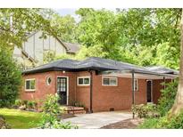 Charming brick home with a covered carport and well-manicured landscaping at 138 Woodlawn Ave, Decatur, GA 30030