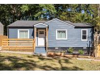 Charming blue home with a cozy front porch and well-maintained landscaping at 205 Maple St, Atlanta, GA 30354