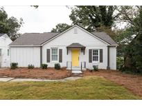 Charming home with a bright yellow front door and well-maintained landscaping at 3198 Oakdale Rd, Atlanta, GA 30354