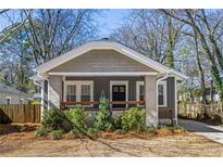 Charming craftsman-style home with a gray exterior, quaint front porch, and well-maintained landscaping at 1045 Moreland Se Ave, Atlanta, GA 30316