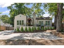 Charming home with a landscaped front yard, awning-covered porch, and large windows at 1423 Briarcliff Ne Rd, Atlanta, GA 30306