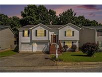 Charming split-level home with a well-maintained lawn, inviting stairs, and an attached two-car garage at 3372 Springside Rdg, Decatur, GA 30034
