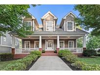Charming two-story home featuring a welcoming front porch, well-maintained landscaping and neutral color palette at 2165 Parkview Nw Run, Atlanta, GA 30318