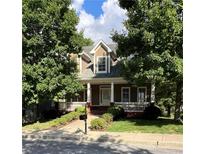 Charming two-story home with a cozy front porch and well-maintained landscaping, nestled among mature trees at 2165 Parkview Nw Run, Atlanta, GA 30318
