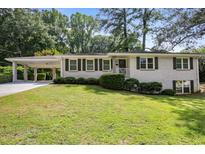Charming brick ranch-style home with manicured lawn and covered carport at 2855 Briarlake Ne Rd, Atlanta, GA 30345