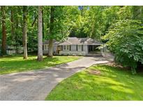 Charming single-story home with a long driveway, mature trees, and a well-maintained lawn at 269 Terrydale Se Dr, Marietta, GA 30067
