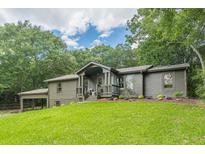 Charming single-story home with a well-manicured lawn and ample curb appeal at 4023 Anvil Block Rd, Ellenwood, GA 30294