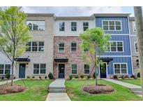 Townhomes with brick and siding exteriors, landscaped yards, and sidewalks at 5477 Blossomwood Sw Trl, Mableton, GA 30126