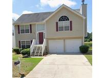 Charming two-story home featuring a two-car garage and well-maintained front yard at 11833 Spring Lake Way, Fayetteville, GA 30215