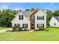 Charming two-story home with a landscaped yard and brick accents at 2479 Heatherton Ct, Dacula, GA 30019