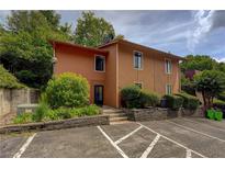 Two-story home with a brown exterior, neatly landscaped front, and convenient parking at 834 Lake Hollow Sw Blvd, Marietta, GA 30064