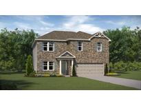 Charming two-story brick home featuring a two-car garage and beautifully landscaped front yard at 1205 Arnhem Dr, Hampton, GA 30228