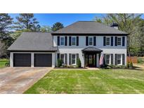 Charming two-story home with painted brick, black shutters, and a well-manicured lawn at 1807 N Chestnut Grove Dr, Marietta, GA 30066