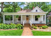 Charming home with a brick pathway, lush landscaping, and a welcoming front porch at 261 Ormond Se St, Atlanta, GA 30315
