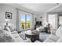 Inviting living room featuring plush seating, a cozy rug, and balcony access for natural light and fresh air at 326 Roswell Se St # 706, Marietta, GA 30060