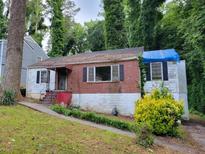 Modest one-story home with brick facade, black shutters, and a cozy front entrance ready for a new owner at 1159 Eastridge Sw Rd, Atlanta, GA 30311